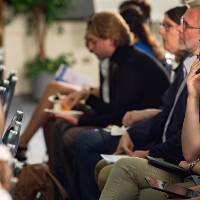 Another photo of audience listening to presentation.